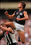 Aaron Hamill flies against the Pies.