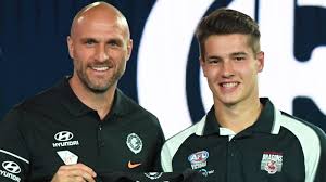2018 Draftee Lian Stocker with Chris Judd.