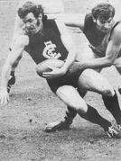 Adrian Gallagher slips under a Tiger tackle.