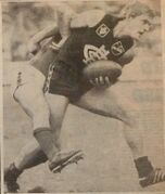 1984 Rd 17 - Paul Meldrum about to brush off a tackler.