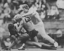 1990 Rd 8 - Peter Dean and runner Trevor Keogh wrestle with Dermott Brereton.Pic: Inside Football.